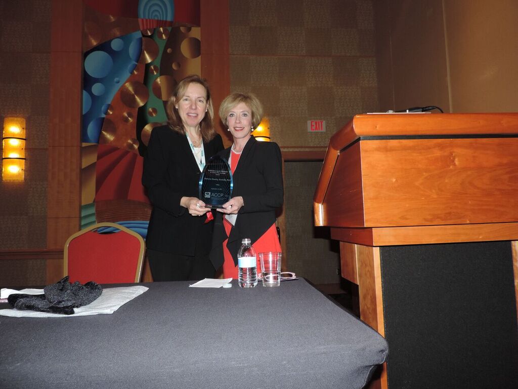 Dr. Patricia Dowley Kroboth receives the  Bristol-Myers Squibb Mentorship Award from Dr. von Moltke