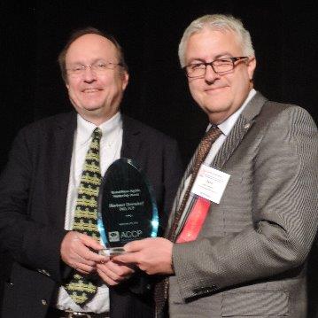 Dr. Hartmut Derendorf receives the Bristol-Meyers Squibb Mentorship Award from Dr. Meibohm